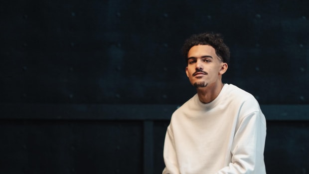 Trae Young modeling new black and white shoes.